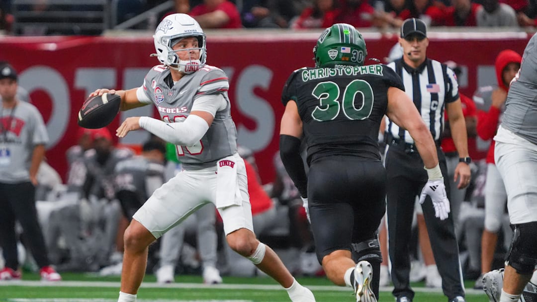Dec 23, 2025; Frisco, TX, USA; UNLV Rebels quarterback Anthony Colandrea (10) stands in the pocket as Ohio Bobcats linebacker Charlie Christopher (30) defends during the second half at the Ford Center at The Star. Dec 23, 2025; Frisco, TX, USA; UNLV Rebels quarterback Anthony Colandrea (10) stands in the pocket as Ohio Bobcats linebacker Charlie Christopher (30) defends during the second half at the Ford Center at The Star.