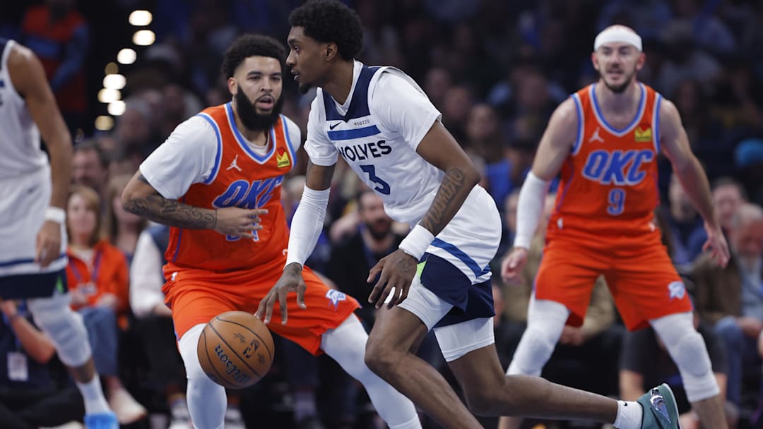 Nov 26, 2025; Oklahoma City, Oklahoma, USA; Minnesota Timberwolves forward Jaden McDaniels (3) moves around Oklahoma City Thunder guard Kenrich Williams (34) during the second quarter at Paycom Center. Mandatory Credit: Alonzo Adams-Imagn Images