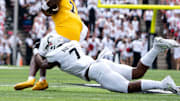 Cincinnati Bearcats linebacker Jared Bartlett (7) tackles Towson Tigers defensive back Kam Snell (7) in the first quarter of the College Football game at Nippert Stadium in Cincinnati on Saturday, Aug. 31, 2024.