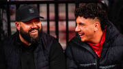 Jan 3, 2024; Lincoln, Nebraska, USA; Nebraska Cornhuskers football assistant coach Donovan Raiola (left) and Dylan Raiola smile before the game against the Indiana Hoosiers at Pinnacle Bank Arena. Dylan is the top quarterback recruit in the 2024 class.