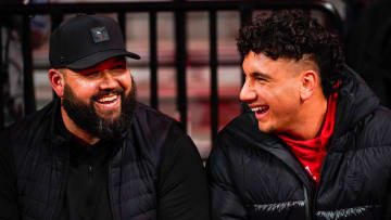 Jan 3, 2024; Lincoln, Nebraska, USA; Nebraska Cornhuskers football assistant coach Donovan Raiola (left) and Dylan Raiola smile before the game against the Indiana Hoosiers at Pinnacle Bank Arena. Dylan is the top quarterback recruit in the 2024 class.