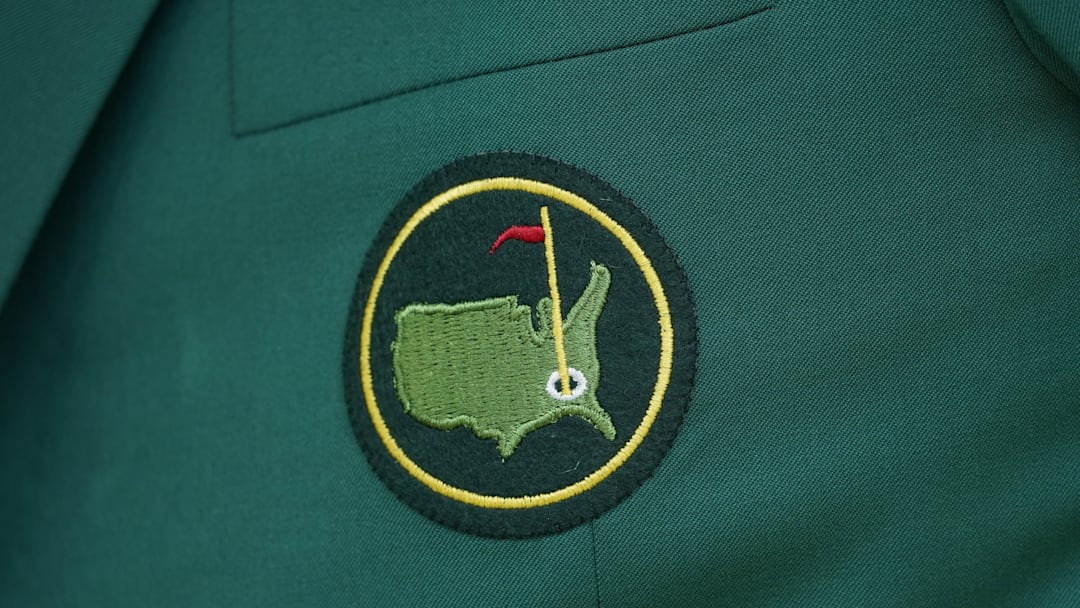 Detailed view of The Masters logo on a member's green jacket