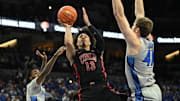 Dec 7, 2024; Omaha, Nebraska, USA;  UNLV Rebels guard Brooklyn Hicks (13) attempts a shot against Creighton Bluejays forward Isaac Traudt (41) in the first half at CHI Health Center Omaha. Mandatory Credit: Steven Branscombe-Imagn Images