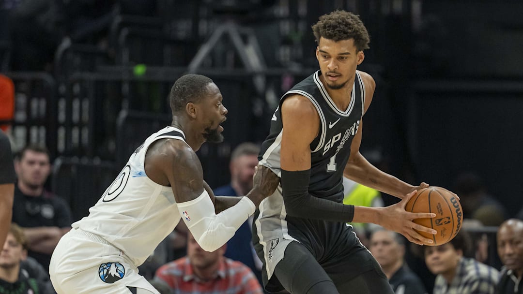 Dec 29, 2024; Minneapolis, Minnesota, USA; San Antonio Spurs center Victor Wembanyama (1) backs towards the basket as Minnesota Timberwolves forward Julius Randle (30) in the first half at Target Center.