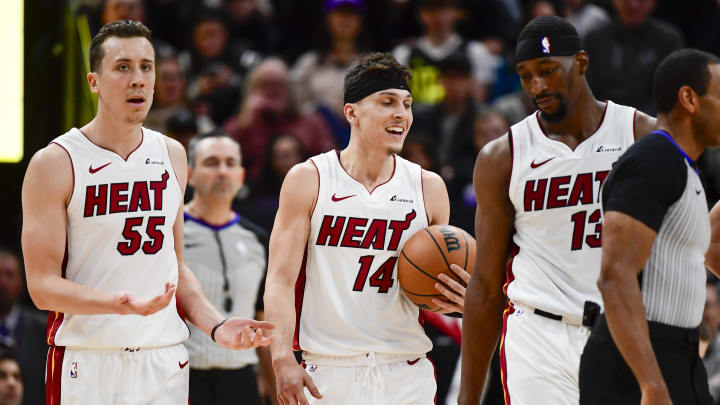 Dec 31, 2022; Salt Lake City, Utah, USA; Miami Heat forward Duncan Robinson (55), center/forward Bam Adebayo (13), and guard Tyler Herro (14) react after a call against the Utah Jazz during the second half at Vivint Arena. Mandatory Credit: Christopher Creveling-USA TODAY Sports