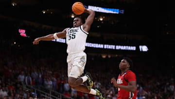 Mar 28, 2025; Atlanta, GA, USA; Michigan State Spartans forward Coen Carr (55) dunks against Mississippi Rebels forward Malik Dia (0) in the second half of a South Regional semifinal of the 2025 NCAA tournament at State Farm Arena. Mandatory Credit: Brett Davis-Imagn Images