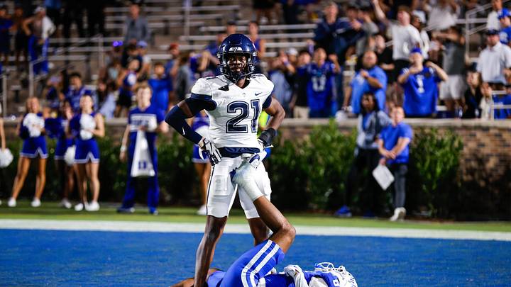 Sep 14, 2024; Durham, North Carolina, USA; Connecticut Huskies defensive back Lee Molette III (21) stands over Duke Blue Devils wide receiver Jordan Moore (8) during the second half of the game against Duke Blue Devils at Wallace Wade Stadium. Mandatory Credit: Jaylynn Nash-Imagn Images