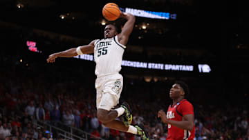 Mar 28, 2025; Atlanta, GA, USA; Michigan State Spartans forward Coen Carr (55) dunks against Mississippi Rebels forward Malik Dia (0) in the second half of a South Regional semifinal of the 2025 NCAA tournament at State Farm Arena. Mandatory Credit: Brett Davis-Imagn Images