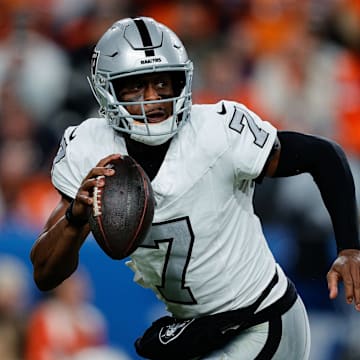 Nov 6, 2025; Denver, Colorado, USA; Las Vegas Raiders quarterback Geno Smith (7) scrambles with the ball in the fourth quarter against the Denver Broncos at Empower Field at Mile High. Mandatory Credit: Isaiah J. Downing-Imagn Images