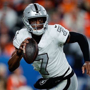 Nov 6, 2025; Denver, Colorado, USA; Las Vegas Raiders quarterback Geno Smith (7) scrambles with the ball in the fourth quarter against the Denver Broncos at Empower Field at Mile High. Mandatory Credit: Isaiah J. Downing-Imagn Images