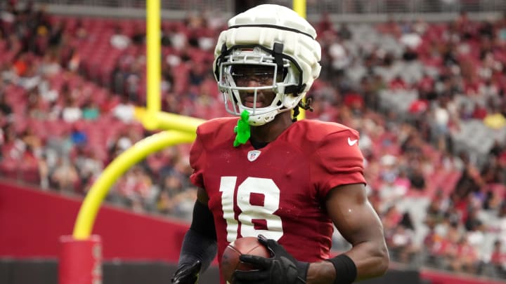 Arizona Cardinals receiver Marvin Harrison Jr. (18) catches a pass in the end zone during training camp at State Farm Stadium in Glendale, Ariz., on Saturday, Aug. 3, 2024.