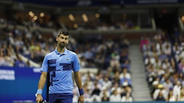 Men's tennis star Novak Djokovic looks at a replay between points against Alexei Popyrin in the 2024 U.S. Open tournament