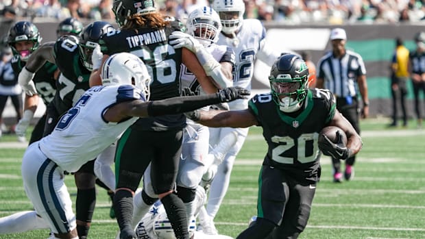 New York Jets running back Breece Hall carries the ball as he works around Dallas Cowboys safety Donovan Wilson