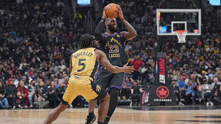 Apr 2, 2024; Toronto, Ontario, CAN; Los Angeles Lakers forward LeBron James (23) controls the ball as Toronto Raptors guard Immanuel Quickley (5) tries to defend during the first quarter at Scotiabank Arena. Mandatory Credit: Nick Turchiaro-Imagn Images