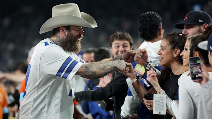 American recording artist Post Malone fist bumps fans before a game between the New York Giants and the Dallas Cowboys