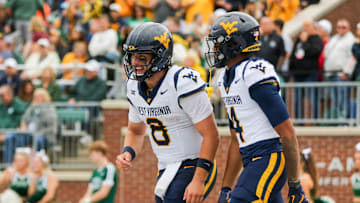 Sep 6, 2025; Athens, Ohio, USA; West Virginia Mountaineers quarterback Nicco Marchiol (8) celebrates with West Virginia Mountaineers wide receiver Cam Vaughn (4) after a touchdown during the first quarter against the Ohio Bobcats at Peden Stadium. Mandatory Credit: Ben Queen-Imagn Images
