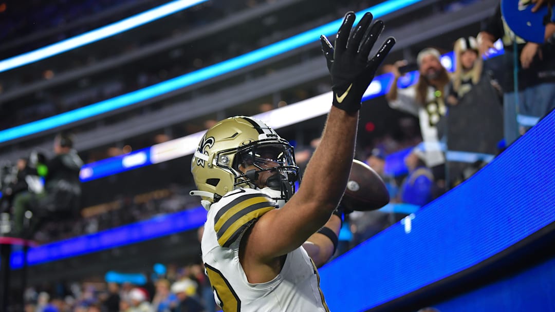 Dec 21, 2023; Inglewood, California, USA; New Orleans Saints wide receiver Chris Olave (12) celebrates after scoring on two point conversion against the Los Angeles Rams during the second half at SoFi Stadium. Mandatory Credit: Gary A. Vasquez-Imagn Images