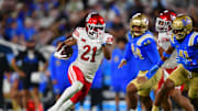 Utah Utes running back NaQuari Rogers (21) runs the ball against the UCLA Bruins during the first half at Rose Bowl.