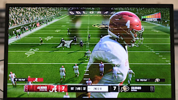 An image of Alabama quarterback Jalen Milroe fades from the screen as kids play the new EA Sports College Football 25 video game at the McDonald Hughes Center in Tuscaloosa.