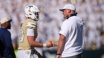 Oct 25, 2025; Atlanta, Georgia, USA; Georgia Tech Yellow Jackets quarterback Haynes King (10) and head coach Brent Key celebrate after at touchdown against the Syracuse Orange in the fourth quarter at Bobby Dodd Stadium at Hyundai Field. Mandatory Credit: Brett Davis-Imagn Images
