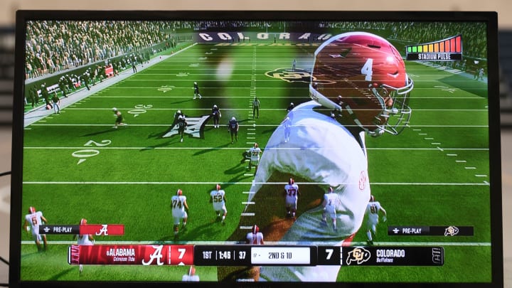 An image of Alabama quarterback Jalen Milroe fades from the screen as kids play the new EA Sports College Football 25 video game at the McDonald Hughes Center in Tuscaloosa.