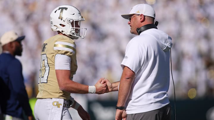 Oct 25, 2025; Atlanta, Georgia, USA; Georgia Tech Yellow Jackets quarterback Haynes King (10) and head coach Brent Key celebrate after at touchdown against the Syracuse Orange in the fourth quarter at Bobby Dodd Stadium at Hyundai Field. Mandatory Credit: Brett Davis-Imagn Images
