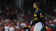 Sep 23, 2025; Cincinnati, Ohio, USA; Pittsburgh Pirates starting pitcher Johan Oviedo (24) walks off the field during a pitching change in the fifth inning against the Cincinnati Reds at Great American Ball Park. Mandatory Credit: Katie Stratman-Imagn Images