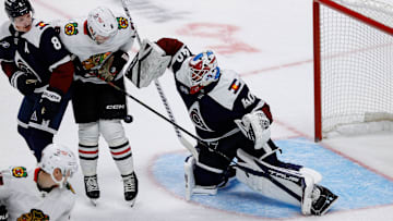 Oct 28, 2024; Denver, Colorado, USA; Colorado Avalanche goaltender Alexandar Georgiev (40) makes a save as Chicago Blackhawks center Ryan Donato (8) and defenseman Cale Makar (8) battle for position in the first period at Ball Arena. Mandatory Credit: Isaiah J. Downing-Imagn Images