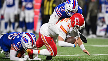 Nov 2, 2025; Orchard Park, New York, USA; Kansas City Chiefs quarterback Patrick Mahomes (15) is brought down by Buffalo Bills defensive end Michael Hoecht (55) and defensive end Greg Rousseau (50) in the third quarter at Highmark Stadium.