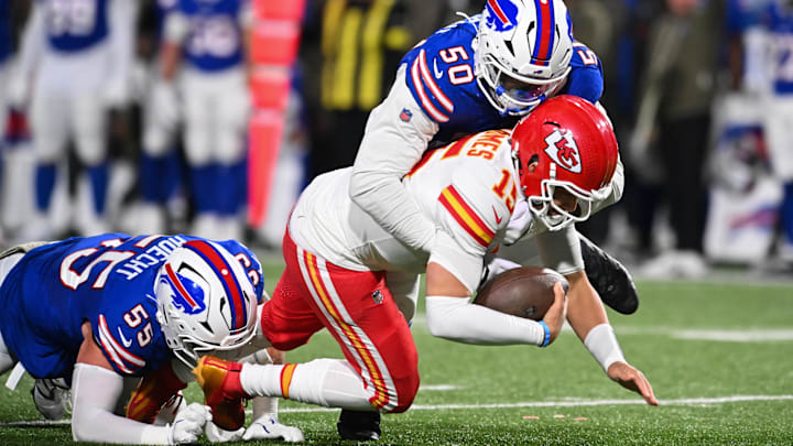 Nov 2, 2025; Orchard Park, New York, USA; Kansas City Chiefs quarterback Patrick Mahomes (15) is brought down by Buffalo Bills defensive end Michael Hoecht (55) and defensive end Greg Rousseau (50) in the third quarter at Highmark Stadium.