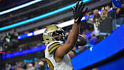 Dec 21, 2023; Inglewood, California, USA; New Orleans Saints wide receiver Chris Olave (12) celebrates after scoring on two point conversion against the Los Angeles Rams during the second half at SoFi Stadium. Mandatory Credit: Gary A. Vasquez-Imagn Images