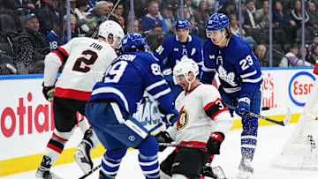 Nov 12, 2024; Toronto, Ontario, CAN; Ottawa Senators defenseman Nick Jensen (3) battles for the puck behind the net with Toronto Maple Leafs left wing Nicholas Robertson (89) during the third period at Scotiabank Arena. Mandatory Credit: Nick Turchiaro-Imagn Images