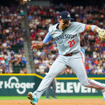 Minnesota Twins third baseman Royce Lewis (23) cannot cleanly field a ground ball at third base during the second inning against the Texas Rangers at Globe Life Field on Aug 17.