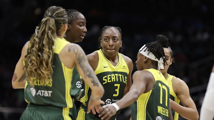 Seattle Storm forward Gabby Williams (5), Seattle Storm forward Nneka Ogwumike (3), Seattle Storm guard Erica Wheeler (17) and others gather against the Golden State Valkyries.