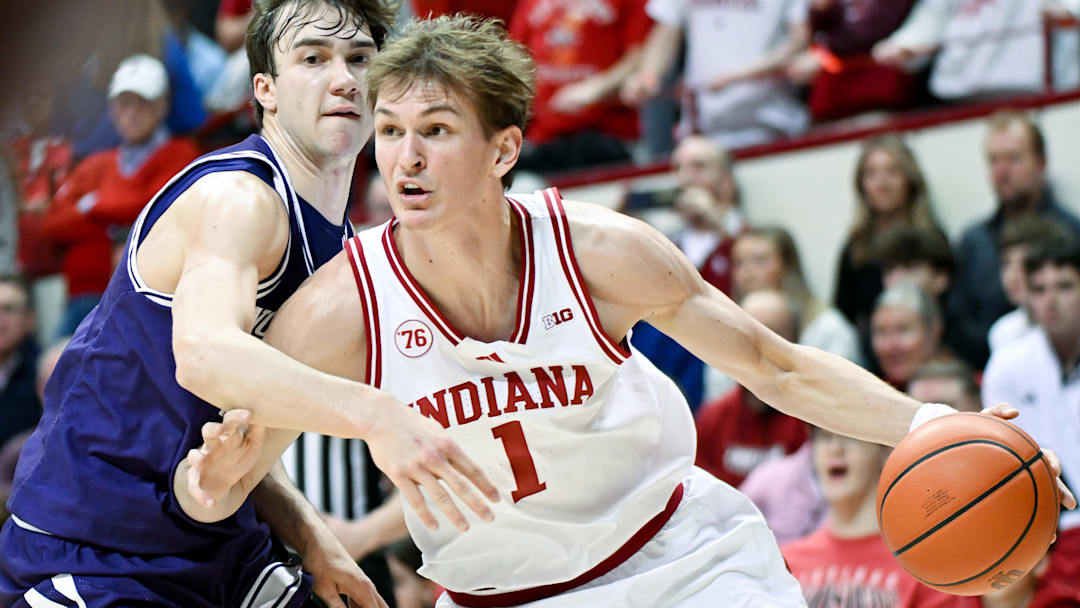 Feb 24, 2026; Bloomington, Indiana, USA; Indiana Hoosiers forward Reed Bailey (1) dribbles against Northwestern Wildcats guard Angelo Ciaravino (44) during the first half at Simon Skjodt Assembly Hall. Mandatory Credit: Robert Goddin-Imagn Images