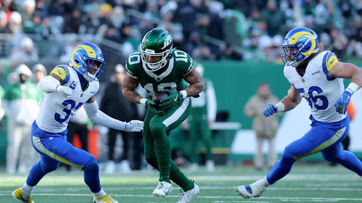 Dec 22, 2024; East Rutherford, New Jersey, USA; New York Jets wide receiver Allen Lazard (10) runs with the ball against Los Angeles Rams safety Quentin Lake (37) and linebacker Christian Rozeboom (56) during the second quarter at MetLife Stadium. Mandatory Credit: Brad Penner-Imagn Images