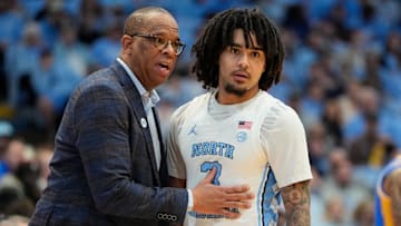 North Carolina Tar Heels head coach Hubert Davis with guard Elliot Cadeau (3) 