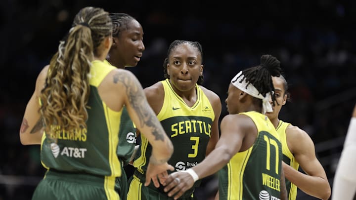 Jul 16, 2025; Seattle, Washington, USA; Seattle Storm forward Gabby Williams (5), Seattle Storm forward Nneka Ogwumike (3), Seattle Storm guard Erica Wheeler (17) and others gather against the Golden State Valkyries during the second half at Climate Pledge Arena. 