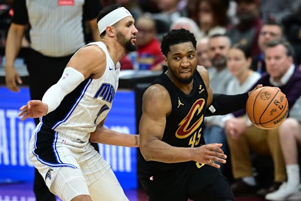 Jalen Suggs of the Orlando Magic defends Cleveland Cavaliers guard Donovan Mitchell during an NBA playoff game