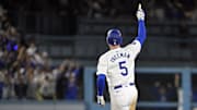 Oct 25, 2024; Los Angeles, California, USA; Los Angeles Dodgers first baseman Freddie Freeman (5) runs after hitting a grand slam home run in the tenth inning against the New York Yankees during game one of the 2024 MLB World Series at Dodger Stadium. 