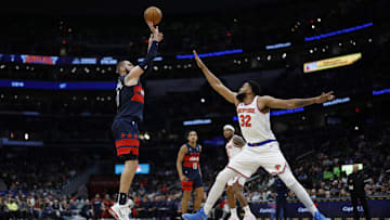 Dec 28, 2024; Washington, District of Columbia, USA; Washington Wizards center Jonas Valanciunas (17) shoots the ball as New York Knicks center Karl-Anthony Towns (32) defends in the fourth quarter at Capital One Arena. Mandatory Credit: Geoff Burke-Imagn Images