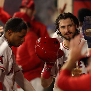 Aug 4, 2025; Anaheim, California, USA;  Los Angeles Angels center fielder Bryce Teodosio (22) is greeted in the dugout after scoring a run during the sixth inning against the Tampa Bay Rays at Angel Stadium. Mandatory Credit: Kiyoshi Mio-Imagn Images
