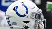 A detailed view of an Indianapolis Colts helmet on the sideline.