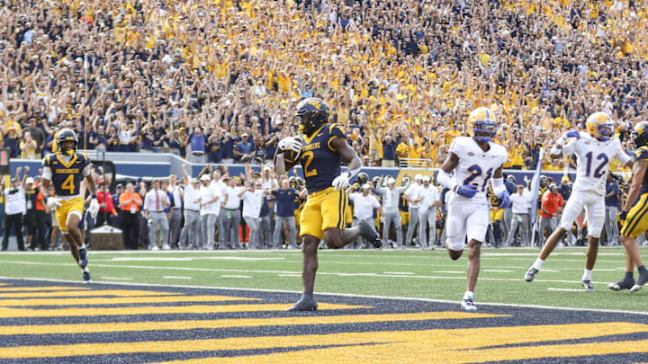 Sep 13, 2025; Morgantown, West Virginia, USA; West Virginia Mountaineers running back Tye Edwards (2) runs the ball for a touchdown during the second quarter against the Pittsburgh Panthers at Milan Puskar Stadium. Mandatory Credit: Ben Queen-Imagn Images