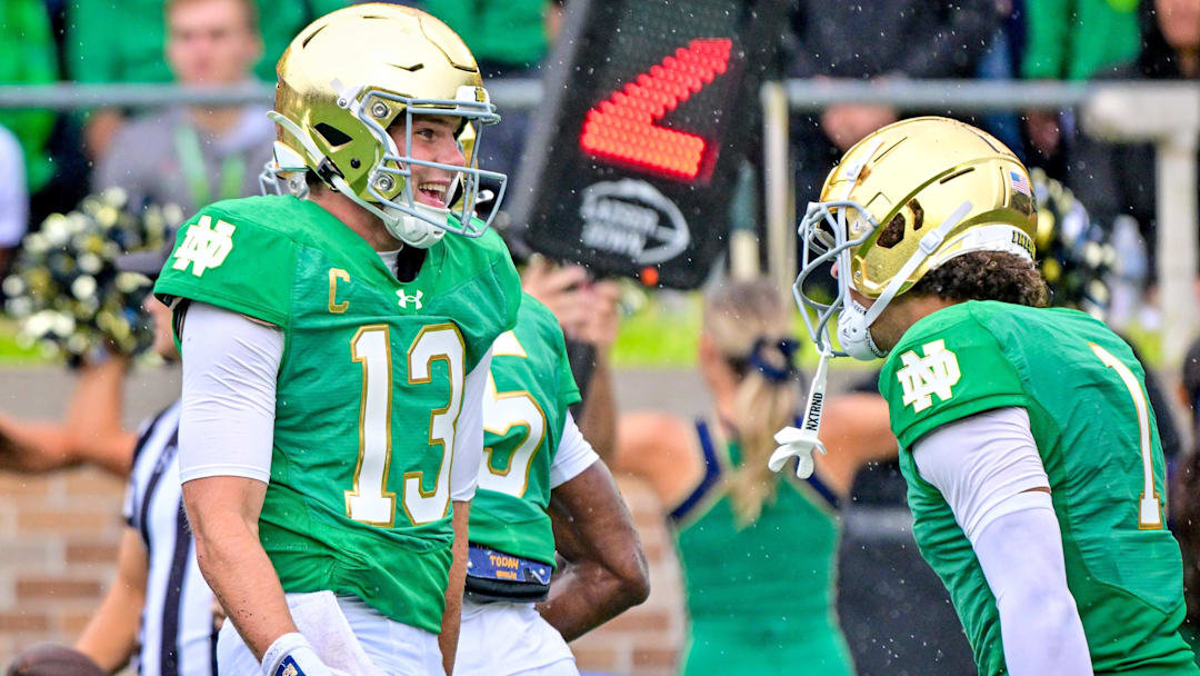 Sep 28, 2024; South Bend, Indiana, USA; Notre Dame Fighting Irish quarterback Riley Leonard (13) celebrates with wide receiver Jaden Greathouse (1) after a touchdown against the Louisville Cardinals in the first quarter at Notre Dame Stadium. 
