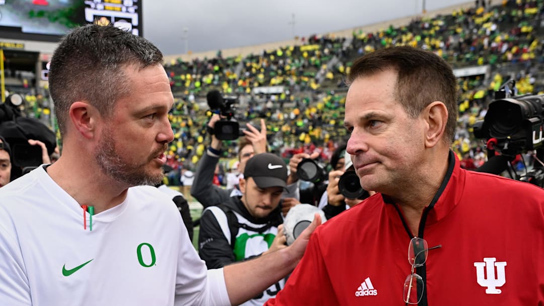 Oct 11, 2025; Eugene, Oregon, USA; Oregon Ducks head coach Dan Lanning shakes hands with Indiana Hoosiers head coach Curt Cignetti after Indiana defeated Oregon by the score of 30-20 at Autzen Stadium. Mandatory Credit: Troy Wayrynen-Imagn Images