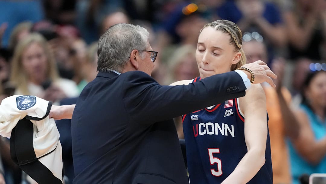 Apr 6, 2025; Tampa, FL, USA; Connecticut Huskies head coach Geno Auriemma hugs guard Paige Bueckers (5) during the second half against the South Carolina Gamecocks of the national championship of the women's 2025 NCAA tournament at Amalie Arena. Mandatory Credit: Kirby Lee-Imagn Images