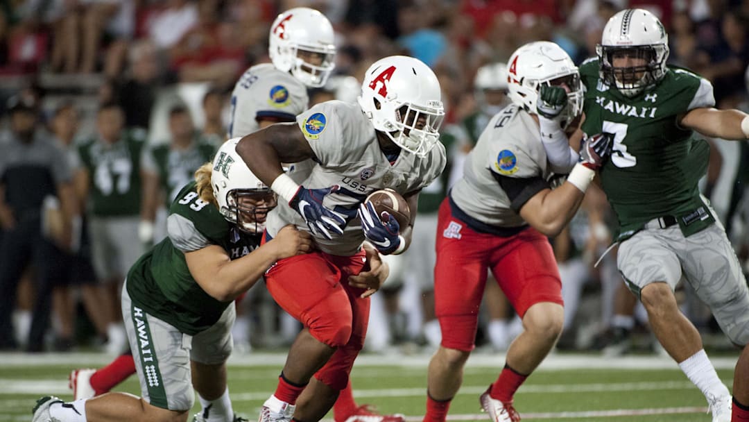 Sep 17, 2016; Tucson, AZ, USA; Arizona Wildcats running back Zach Green (34) runs the ball as he is tackled by Hawaii Warriors defensive lineman Zeno Choi (99) during the fourth quarter at Arizona Stadium. Mandatory Credit: Casey Sapio-Imagn Images