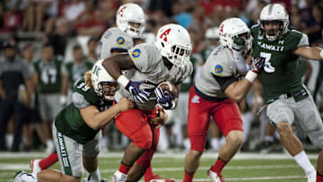 Sep 17, 2016; Tucson, AZ, USA; Arizona Wildcats running back Zach Green (34) runs the ball as he is tackled by Hawaii Warriors defensive lineman Zeno Choi (99) during the fourth quarter at Arizona Stadium. Mandatory Credit: Casey Sapio-Imagn Images