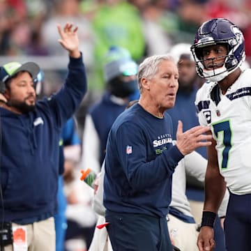 Jan 7, 2024; Glendale, Arizona, USA; Seattle Seahawks head coach Pete Carroll talks with Seattle Seahawks quarterback Geno Smith (7) against the Arizona Cardinals during the first half at State Farm Stadium. Mandatory Credit: Joe Camporeale-Imagn Images